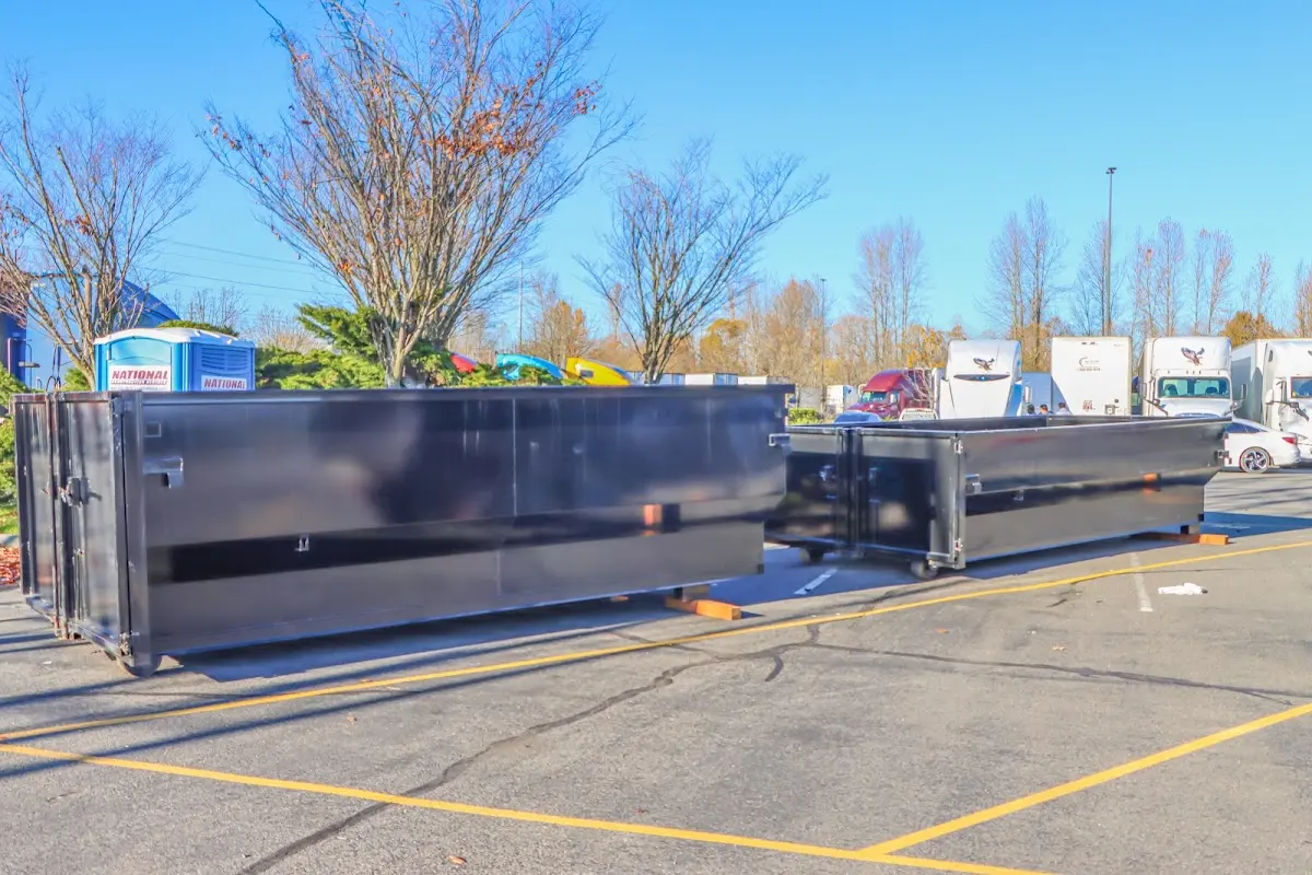 Professional dumpster rental service with roll-off container on residential driveway in Ocean Pines